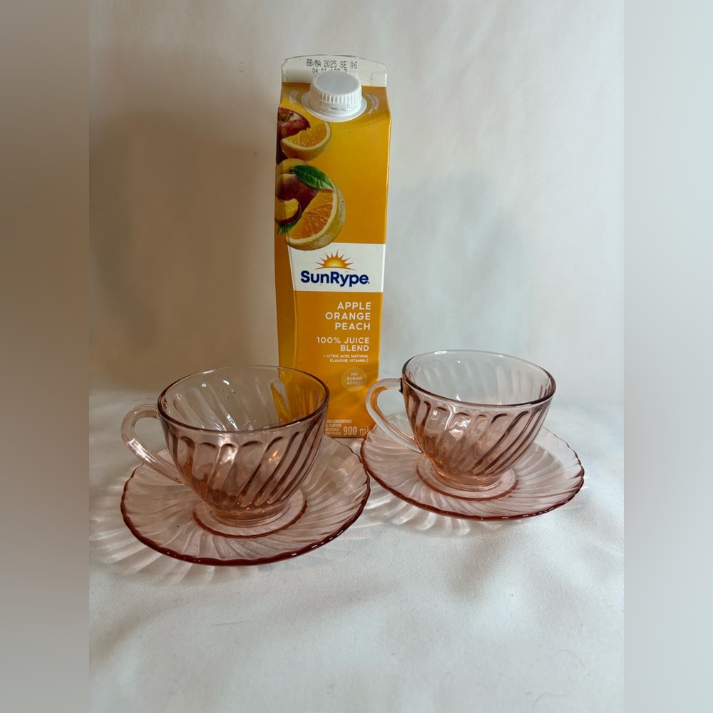 Two pink swirl tea cup, and saucer sets